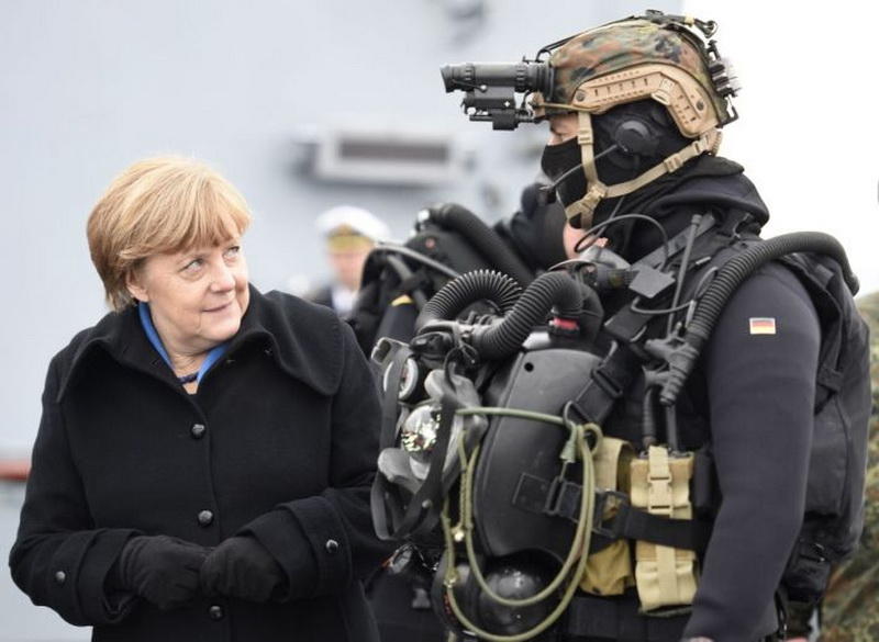 German Chancellor Angela Merkel looks at a combat diver during her visit to Naval Base Command in Kiel, Germany, January 19, 2016. REUTERS/Fabian Bimmer TPX IMAGES OF THE DAY - RTX2325P