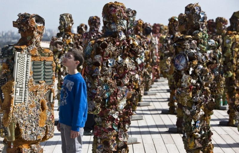 A boy looks at a statue by German artist HA Schult during a preview of the artist's exhibition at the Ariel Sharon Park near Tel Aviv April 2, 2014. Schult's 
